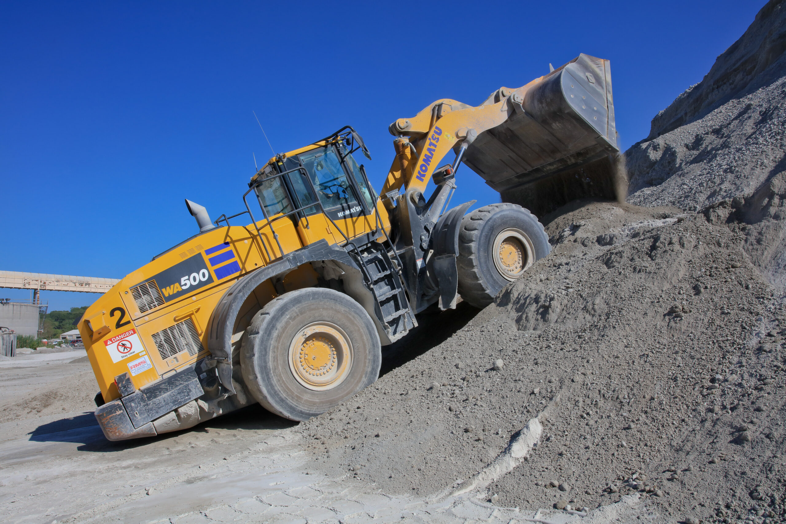 A wheel loader moving rock material.